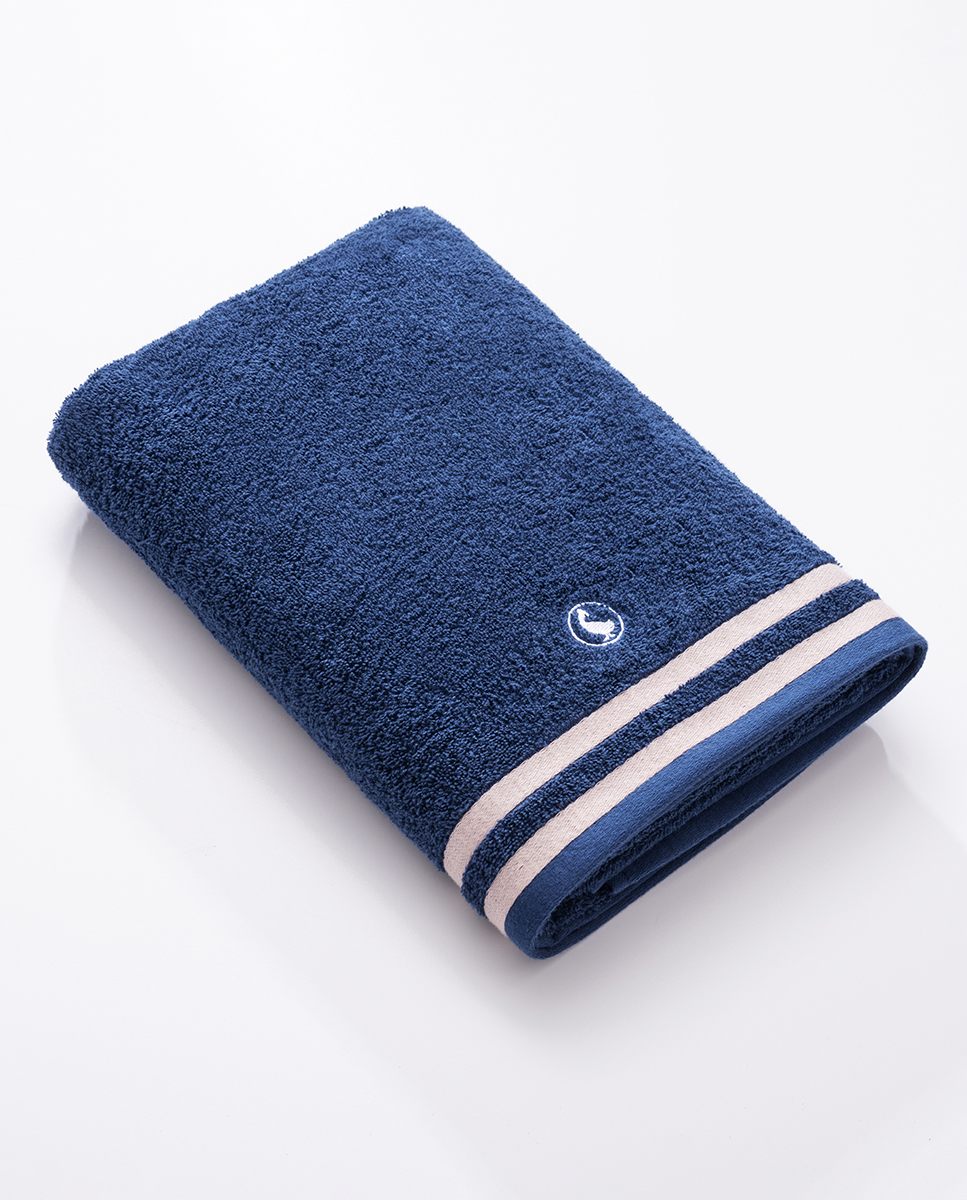 100% cotton bath towel (Weight 500 g m²). Plain cotton bath towel with embroidered logo and red and blue border. Extra soft and highly absorbent. Measurements: 70*140cm